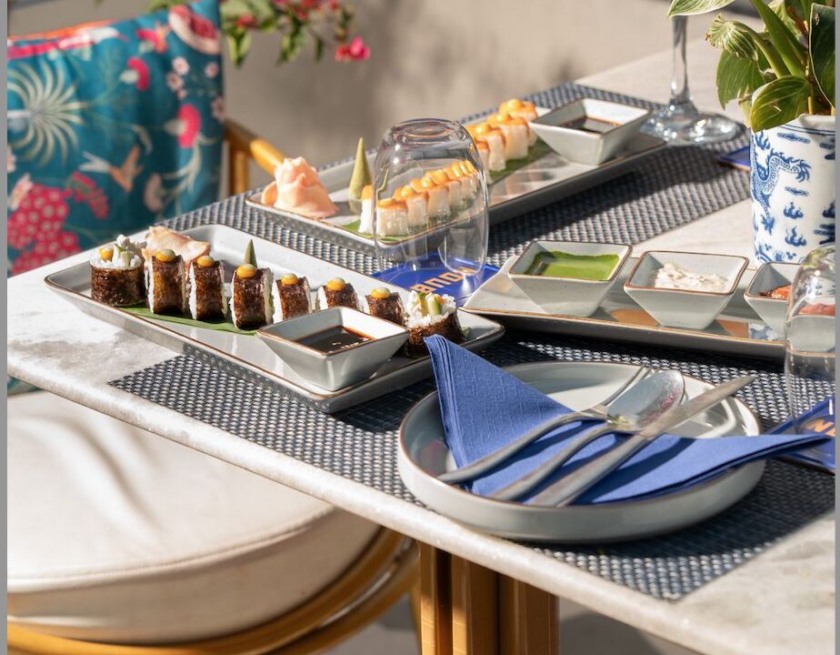Sushi platter on a dark tray with blue napkin at Nouba Restaurant and Rooftop Lounge, C-Scheme Jaipur