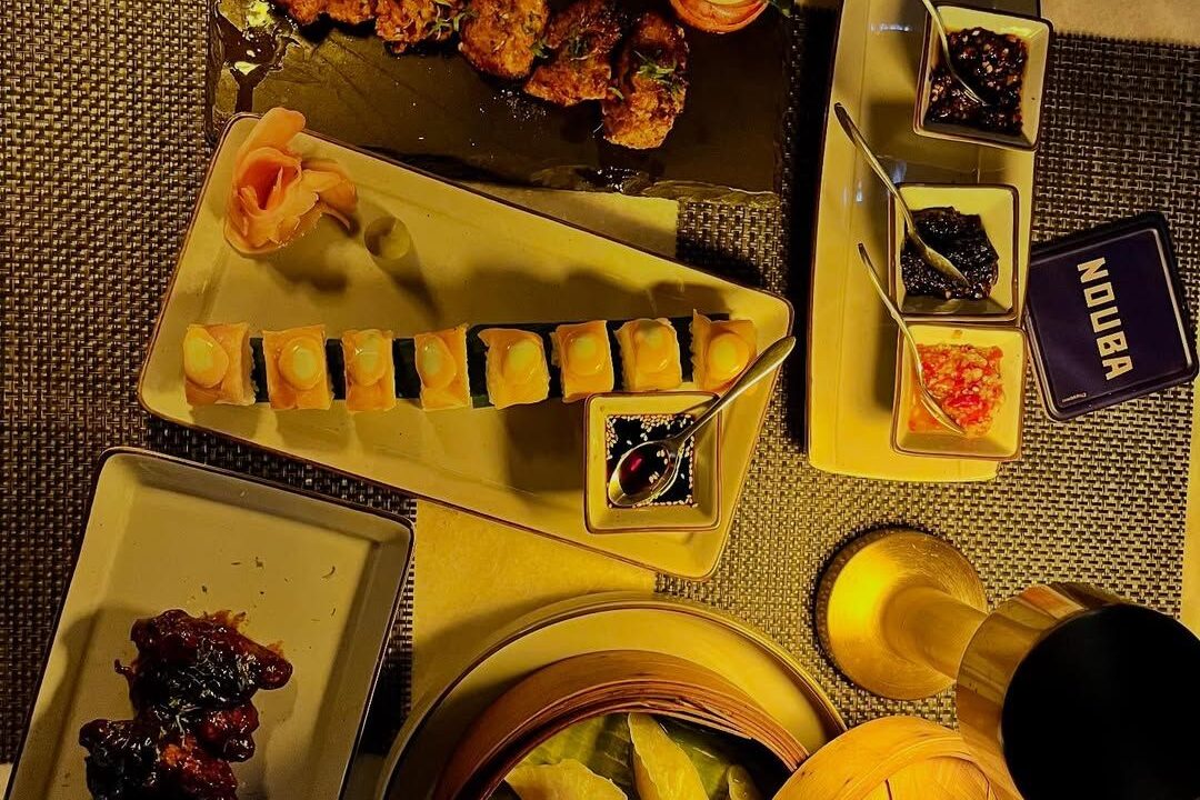 Overhead yellow table setting with menus at Nouba Restaurant and Rooftop Lounge, C-Scheme Jaipur
