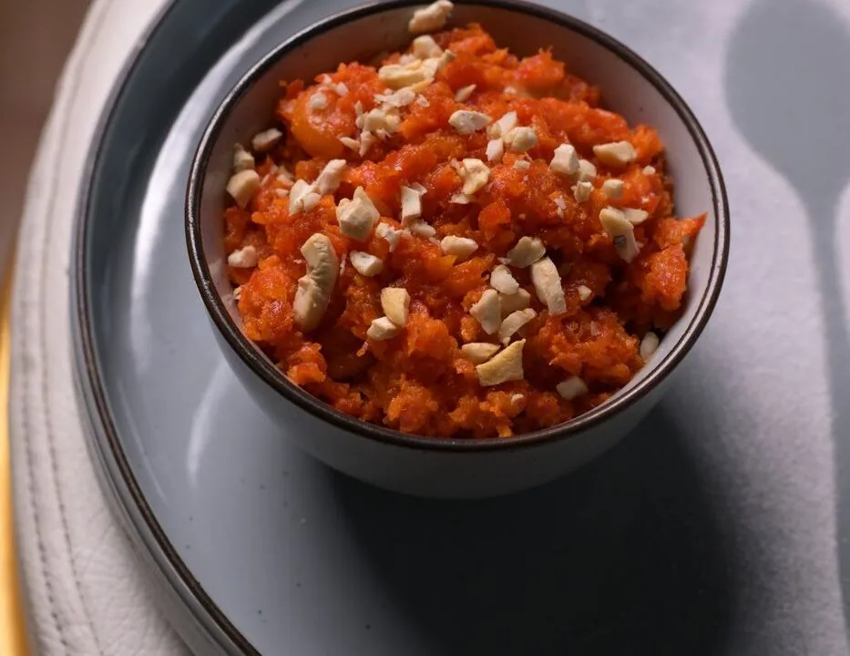 Gajar halwa with cashews in a dark bowl at Nouba Restaurant and Rooftop Lounge, C-Scheme Jaipur