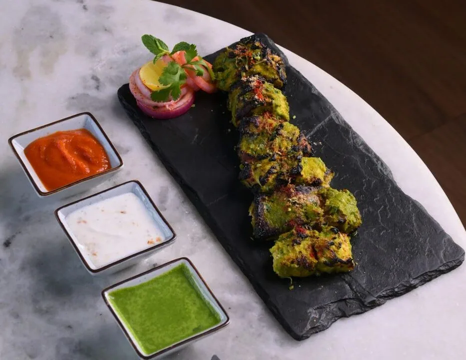 Avocado sushi roll on slate with dipping sauces at Nouba Restaurant and Rooftop Lounge, C-Scheme Jaipur