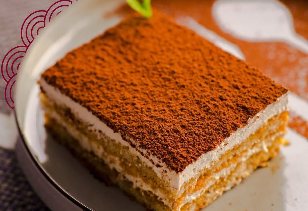 Tiramisu slice dusted with cocoa at Nouba Restaurant and Rooftop Lounge, C-Scheme Jaipur