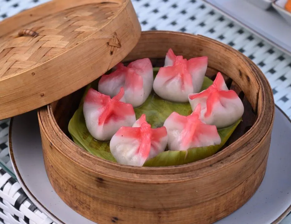 Pink dumplings in a bamboo steamer at Nouba Restaurant and Rooftop Lounge, C-Scheme Jaipur