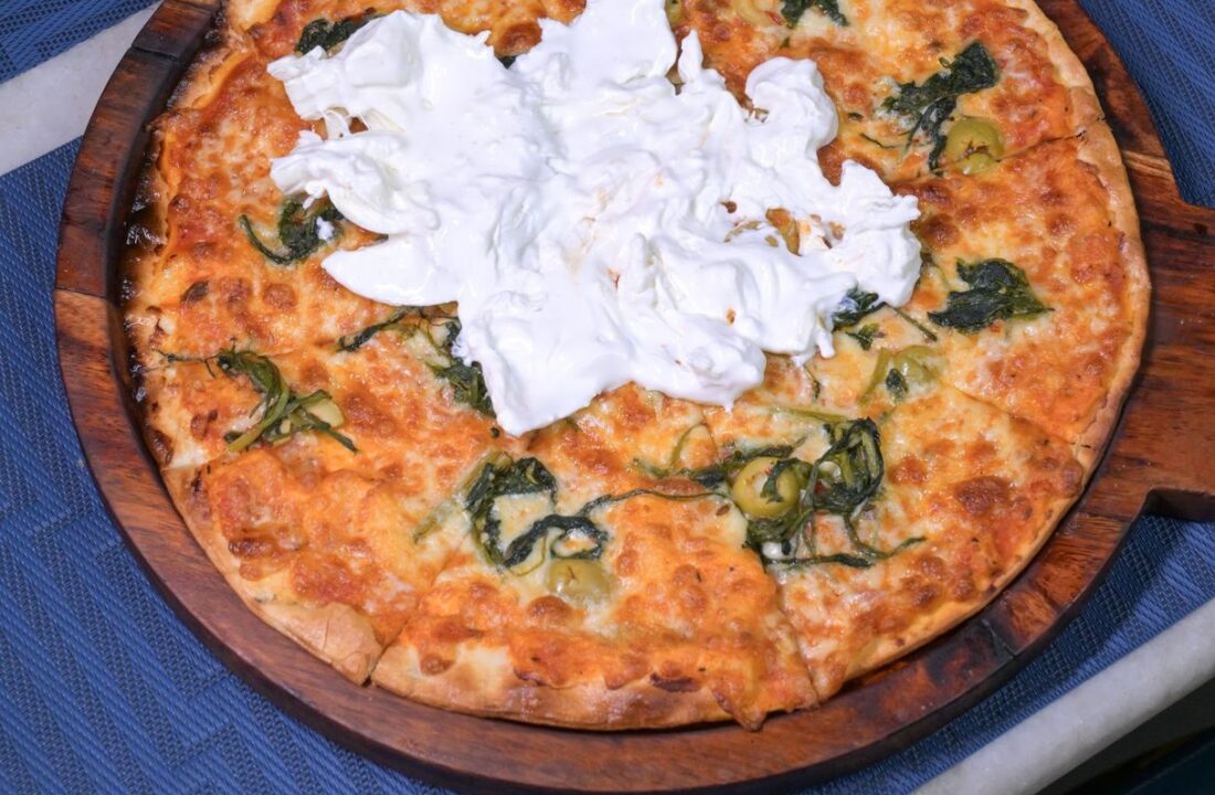 White pizza with cheese and basil at Nouba Restaurant and Rooftop Lounge, C-Scheme Jaipur