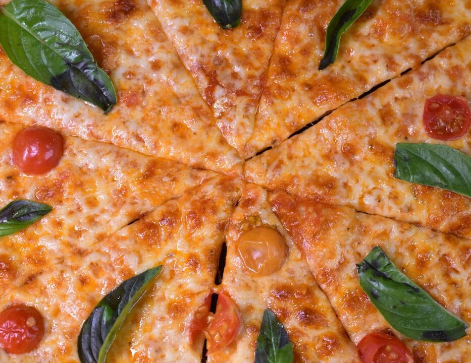 Whole cheese pizza sliced at Nouba Restaurant and Rooftop Lounge, C-Scheme Jaipur
