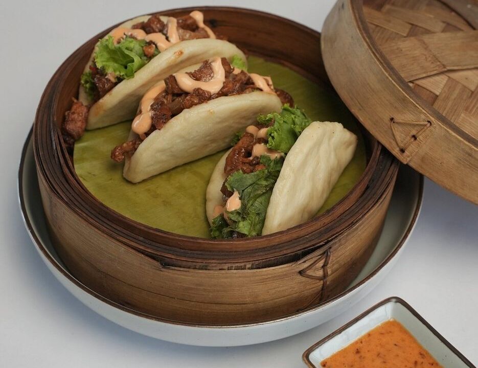 Bao buns in a steamer with greens at Nouba Restaurant and Rooftop Lounge, C-Scheme Jaipur