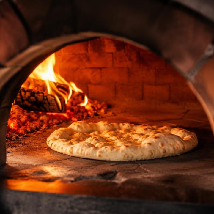 Neapolitan wood-fired pizza oven with bubbling dough at Nouba Restaurant and Rooftop Lounge, C-Scheme Jaipur
