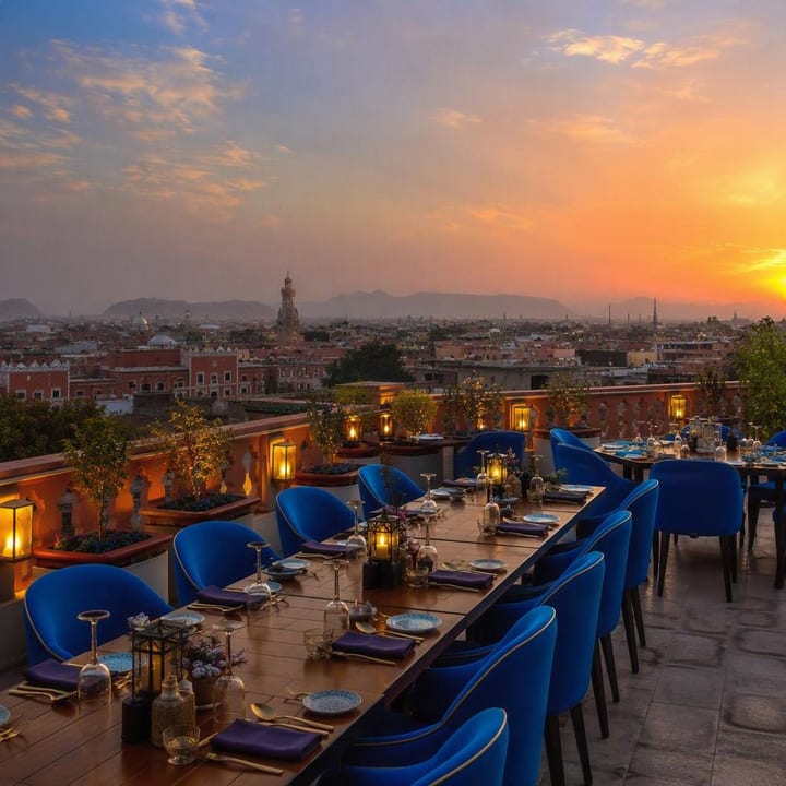 Electric blue rooftop dining area with 180-degree Jaipur skyline view at Nouba Restaurant and Rooftop Lounge, C-Scheme Jaipur
