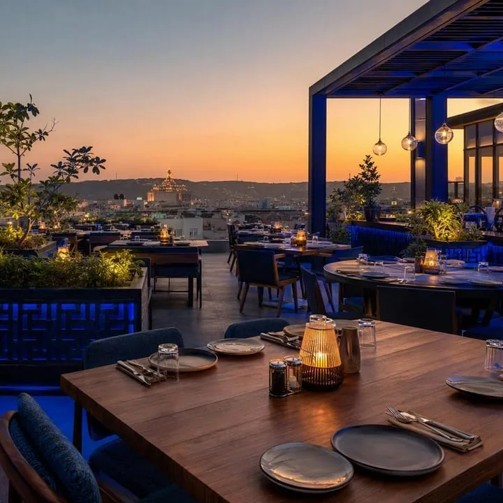 Rooftop tables with Jaipur skyline view at night at Nouba Restaurant and Rooftop Lounge, C-Scheme Jaipur