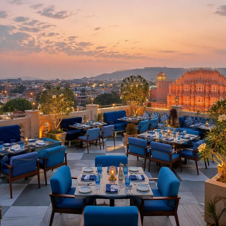 Electric blue rooftop dining area with 180-degree Jaipur skyline view at sunset at Nouba Restaurant and Rooftop Lounge, C-Scheme Jaipur