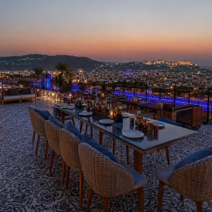 Rooftop tables set for a private group event with Jaipur skyline view at Nouba Restaurant and Rooftop Lounge, C-Scheme Jaipur