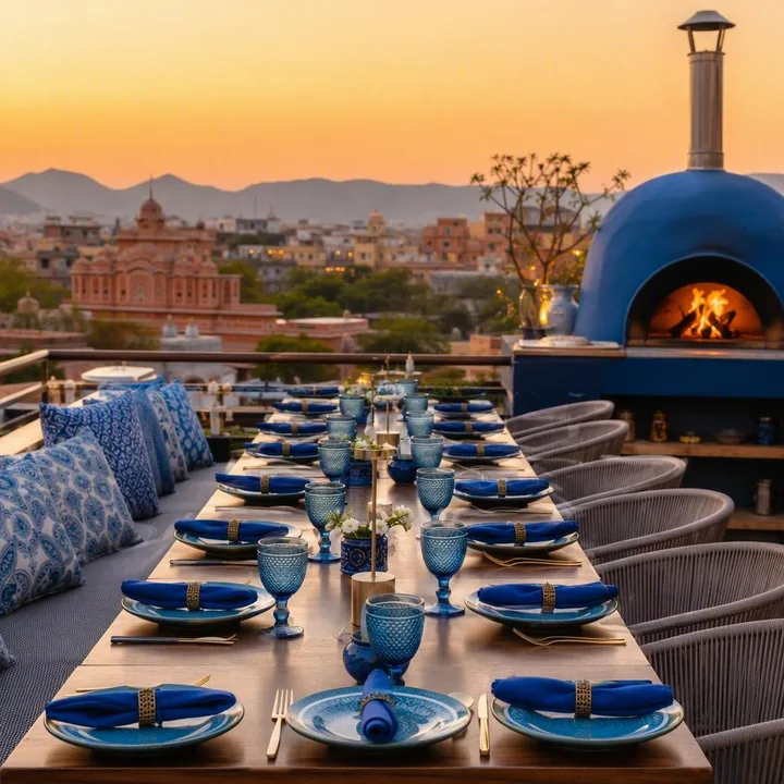 Rooftop tables set for large group dinner with Jaipur skyline view at Nouba Restaurant and Rooftop Lounge, C-Scheme Jaipur