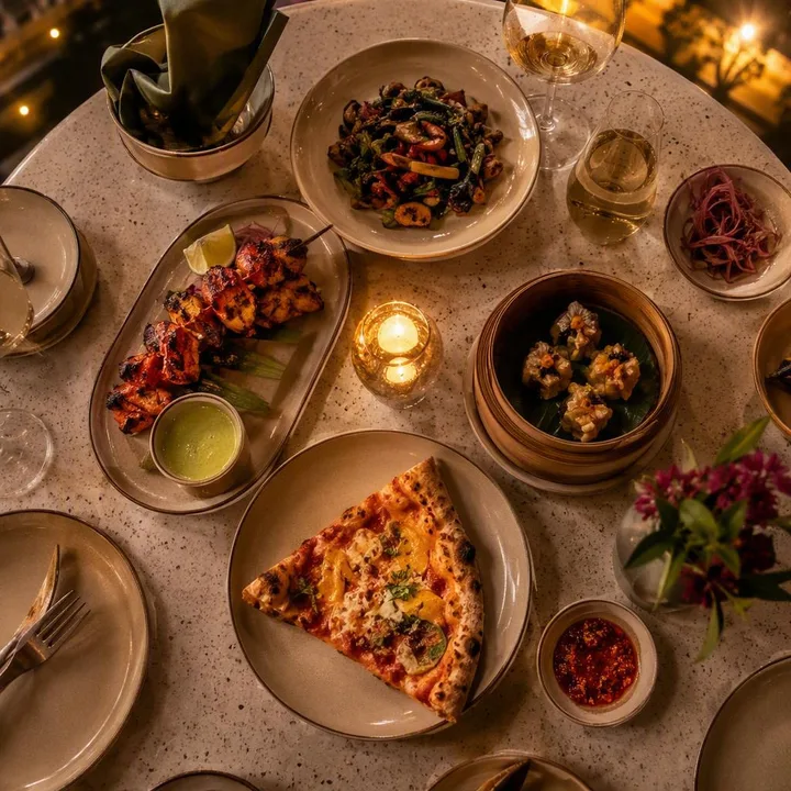 Set table with shared plates from three kitchens at Nouba Restaurant and Rooftop Lounge, C-Scheme Jaipur