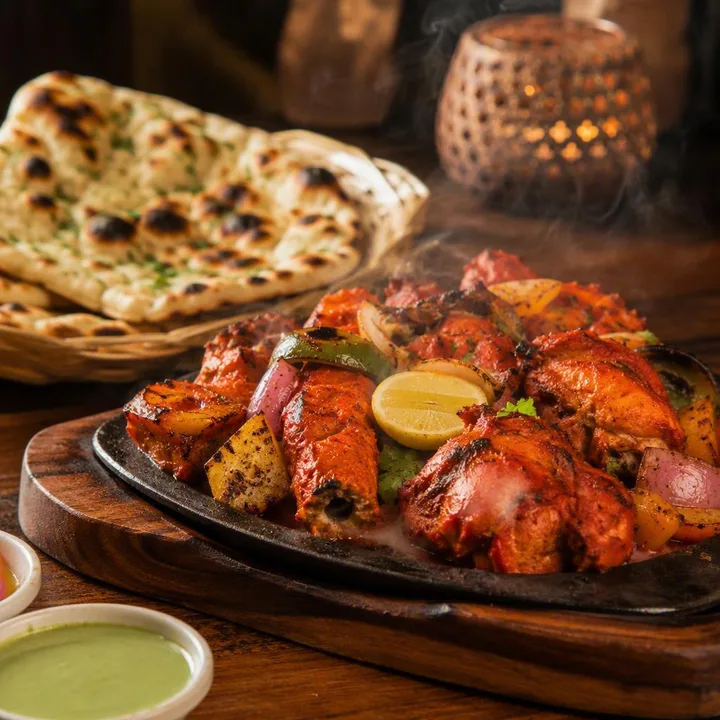 Tandoor grill platter with naan breads and side dishes at Nouba Restaurant and Rooftop Lounge, C-Scheme Jaipur