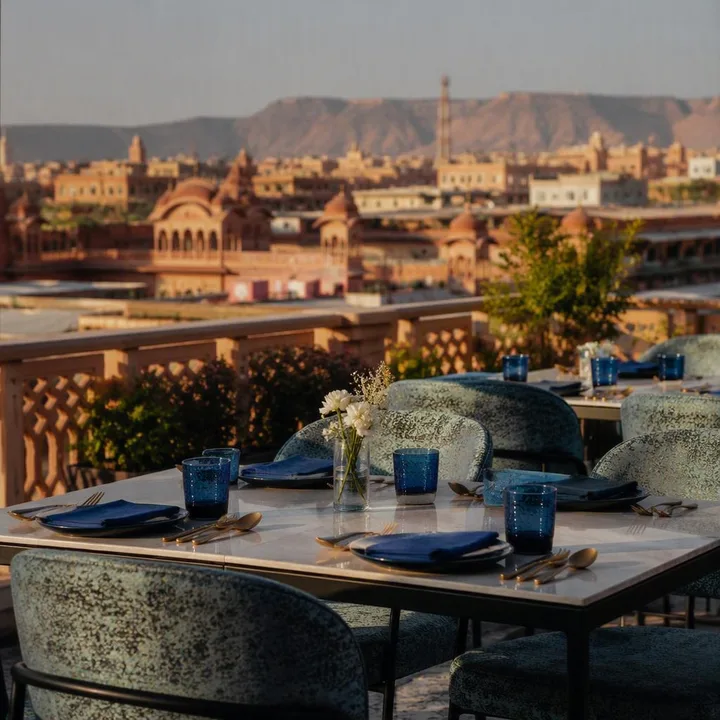 Rooftop tables set for a group lunch with skyline view at Nouba Restaurant and Rooftop Lounge, C-Scheme Jaipur