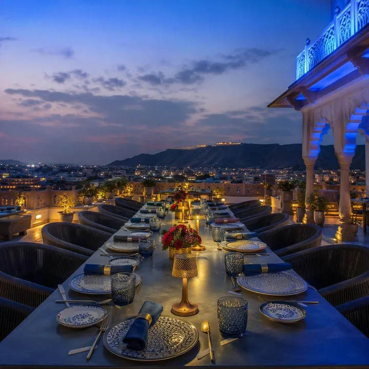 Rooftop table setup for private group dining with skyline view at Nouba Restaurant and Rooftop Lounge, C-Scheme Jaipur