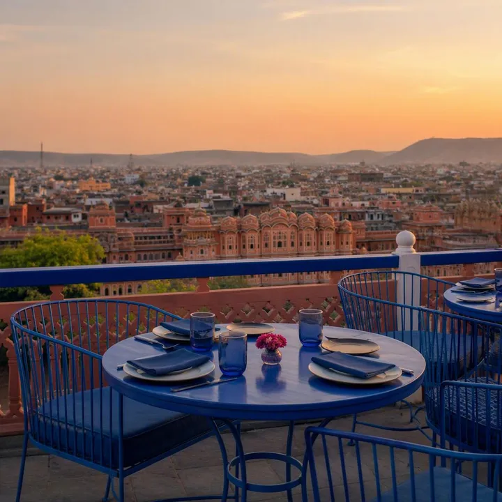 Electric blue rooftop tables with 180-degree Jaipur skyline at dusk at Nouba Restaurant and Rooftop Lounge, C-Scheme Jaipur