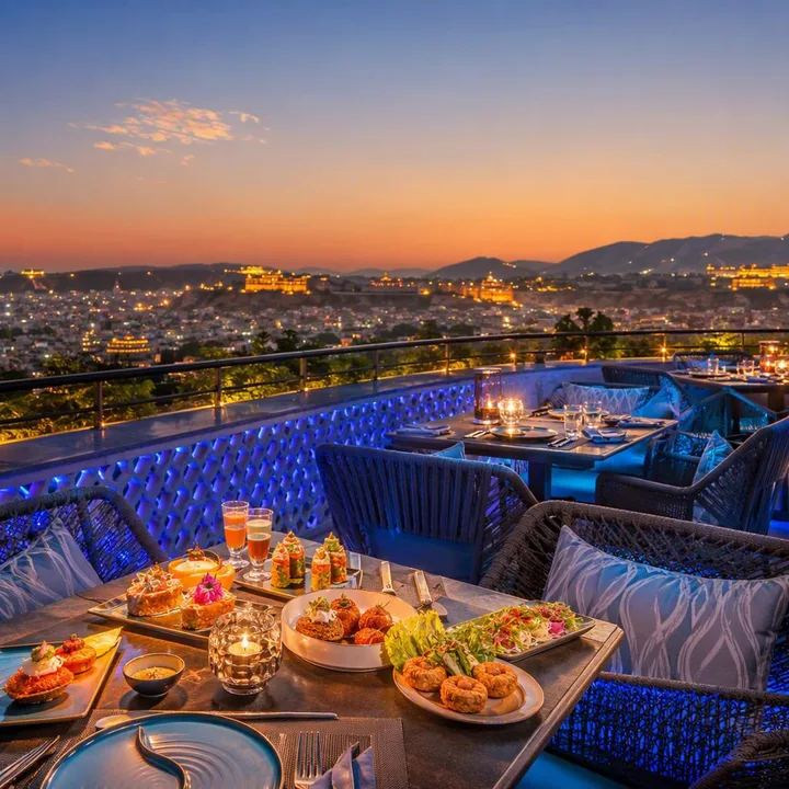 Rooftop tables set for group dinner with Jaipur skyline view at Nouba Restaurant and Rooftop Lounge, C-Scheme Jaipur