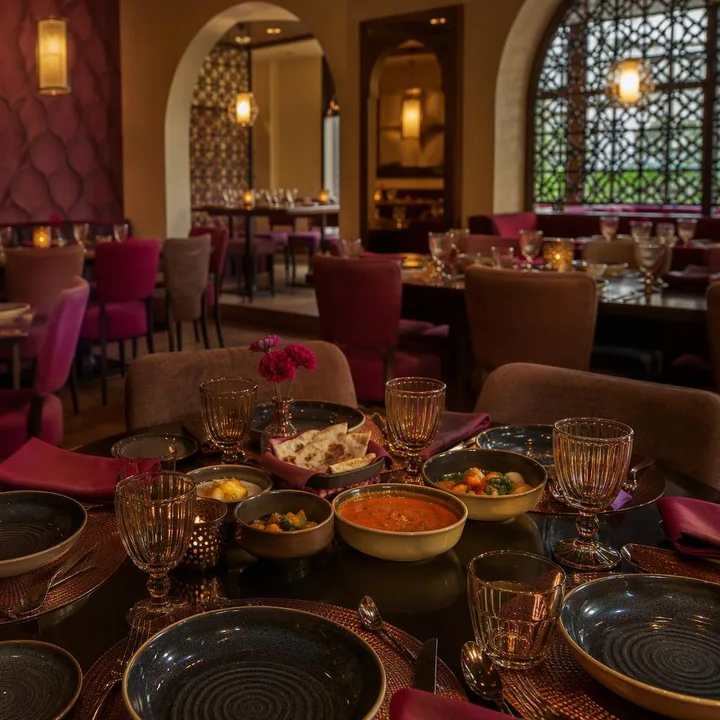 Brown and magenta indoor dining tables on 3rd floor at Nouba Restaurant and Rooftop Lounge, C-Scheme Jaipur