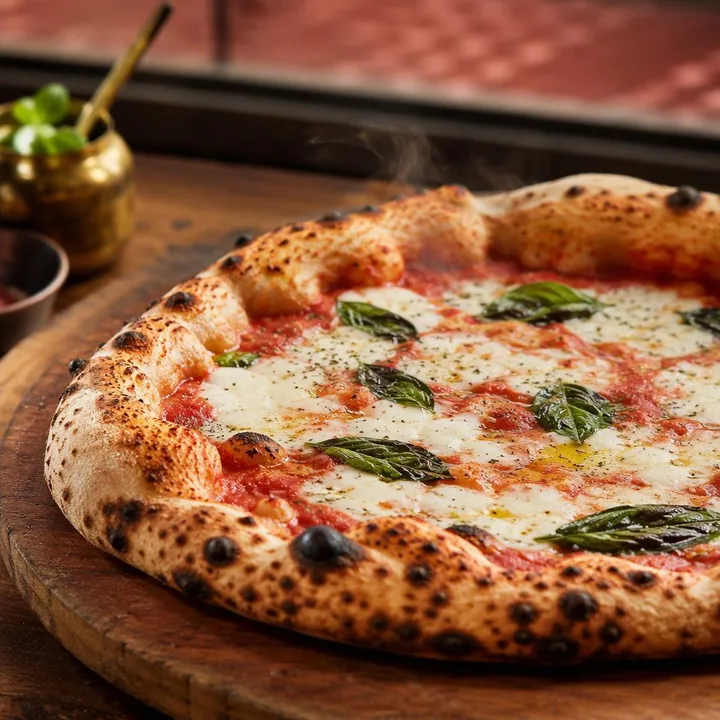 Wood-fired Neapolitan pizza from the oven at Nouba Restaurant and Rooftop Lounge, C-Scheme Jaipur