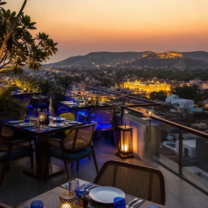 Rooftop tables set for family group dinner with Jaipur skyline view at Nouba Restaurant and Rooftop Lounge, C-Scheme Jaipur