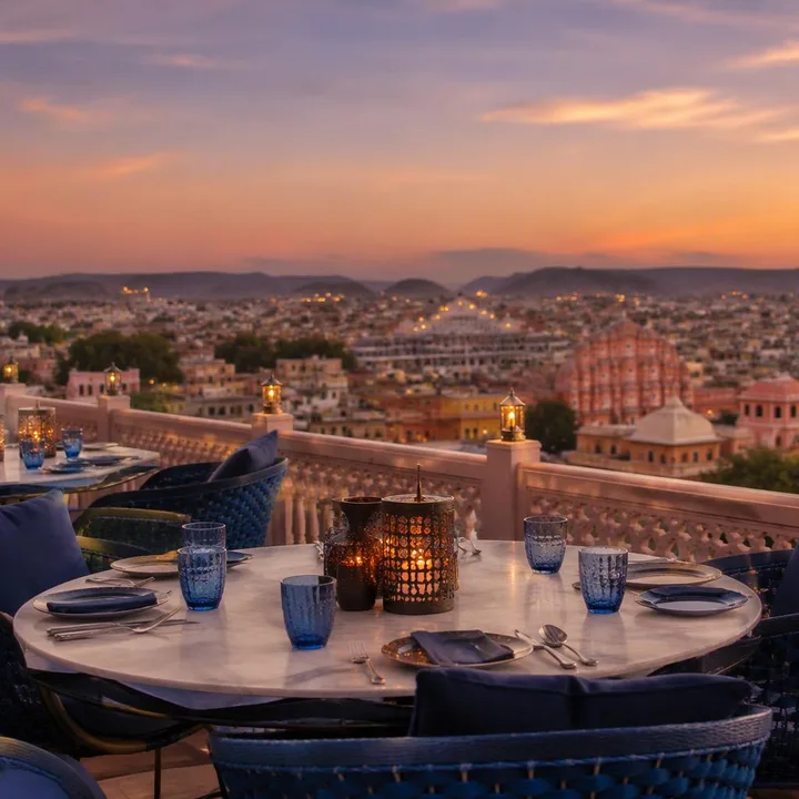 Rooftop table with Jaipur skyline view at dusk at Nouba Restaurant and Rooftop Lounge, C-Scheme Jaipur