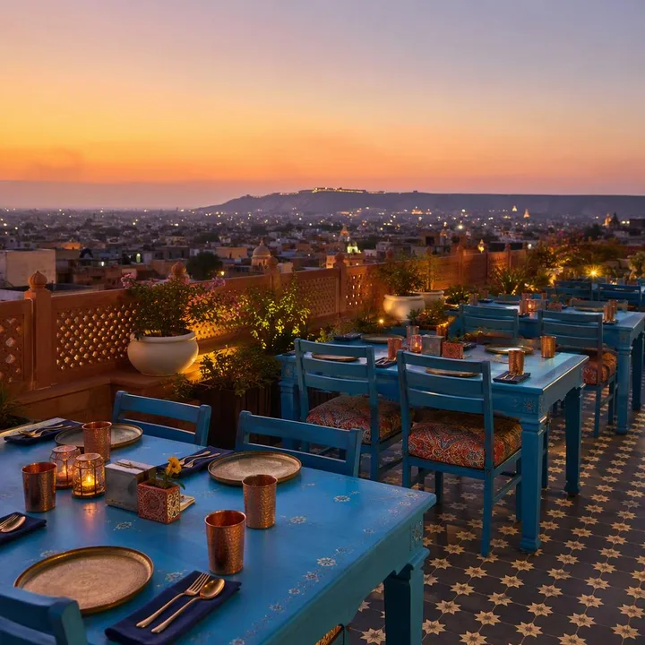 Rooftop tables with Jaipur skyline at sunset at Nouba Restaurant and Rooftop Lounge, C-Scheme Jaipur