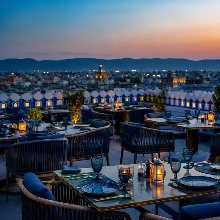 Electric blue rooftop tables with Jaipur skyline at dusk at Nouba Restaurant and Rooftop Lounge, C-Scheme Jaipur
