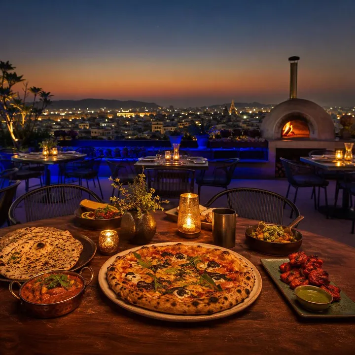 Electric blue rooftop dining area with 180-degree Jaipur skyline view at night at Nouba Restaurant and Rooftop Lounge, C-Scheme Jaipur