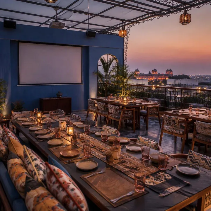 Rooftop table setup with AV screen and Jaipur skyline view at Nouba Restaurant and Rooftop Lounge, C-Scheme Jaipur