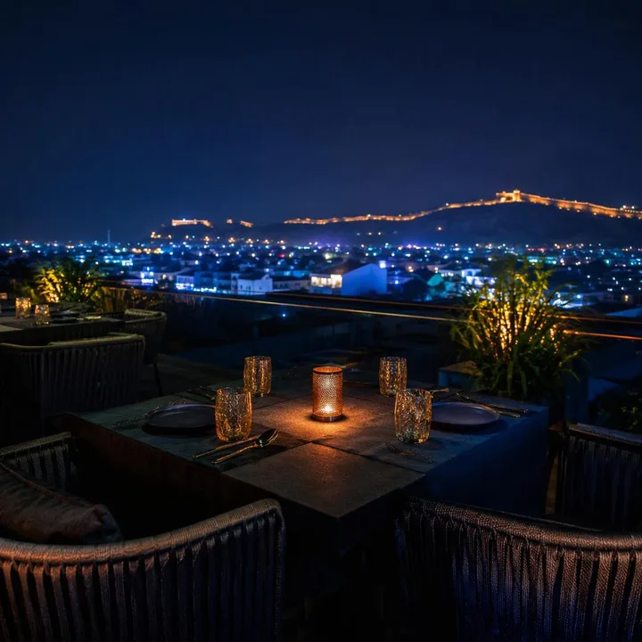 Electric blue rooftop tables with Jaipur skyline view at night at Nouba Restaurant and Rooftop Lounge, C-Scheme Jaipur