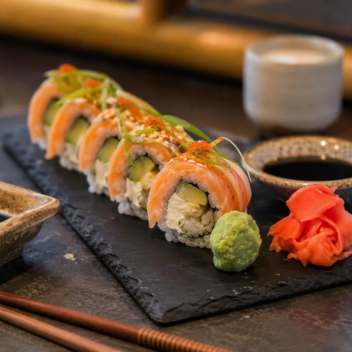 Sushi rolls on a plate with chopsticks at Nouba Restaurant and Rooftop Lounge, C-Scheme Jaipur