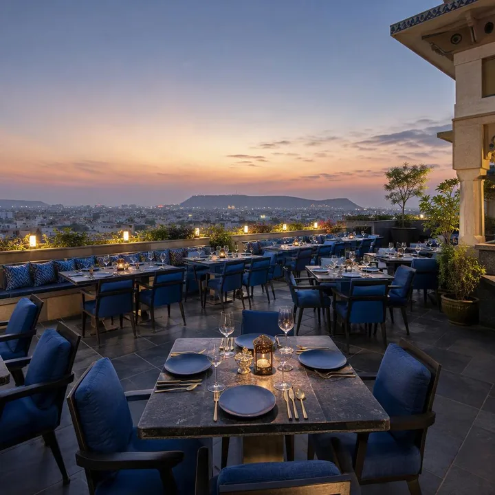 Rooftop tables with Jaipur skyline view at sunset at Nouba Restaurant and Rooftop Lounge, C-Scheme Jaipur