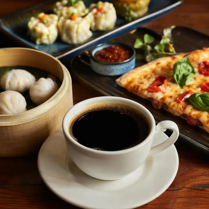 Coffee cup and small plates on table at Nouba Restaurant and Rooftop Lounge, C-Scheme Jaipur
