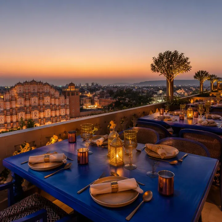 Electric blue rooftop tables with Jaipur skyline at dusk at Nouba Restaurant and Rooftop Lounge, C-Scheme Jaipur