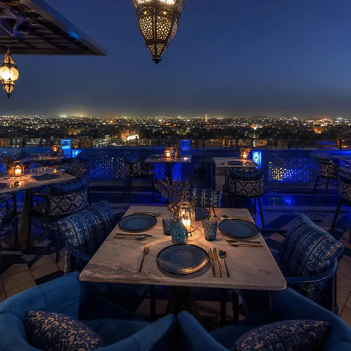 Rooftop tables with Jaipur skyline view at night at Nouba Restaurant and Rooftop Lounge, C-Scheme Jaipur
