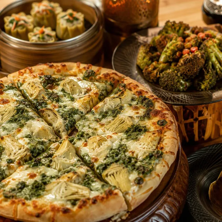 Spinach artichoke pizza on wood board with dim sum and tandoor skewers nearby at Nouba Restaurant and Rooftop Lounge, C-Scheme Jaipur
