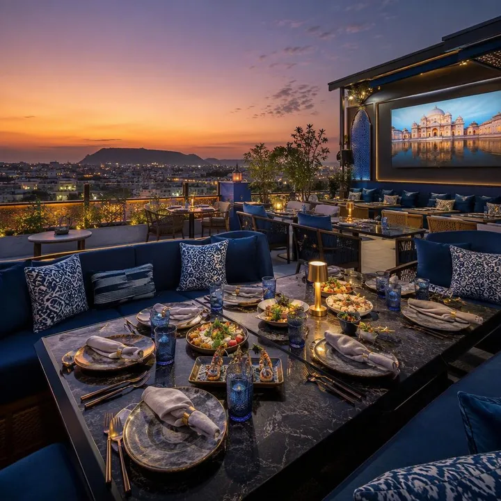 Rooftop dining area with AV screen setup and Jaipur skyline view at Nouba Restaurant and Rooftop Lounge, C-Scheme Jaipur