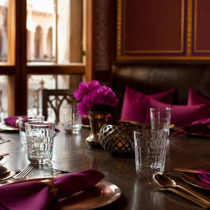 Indoor dining room with brown and magenta decor during monsoon at Nouba Restaurant and Rooftop Lounge, C-Scheme Jaipur