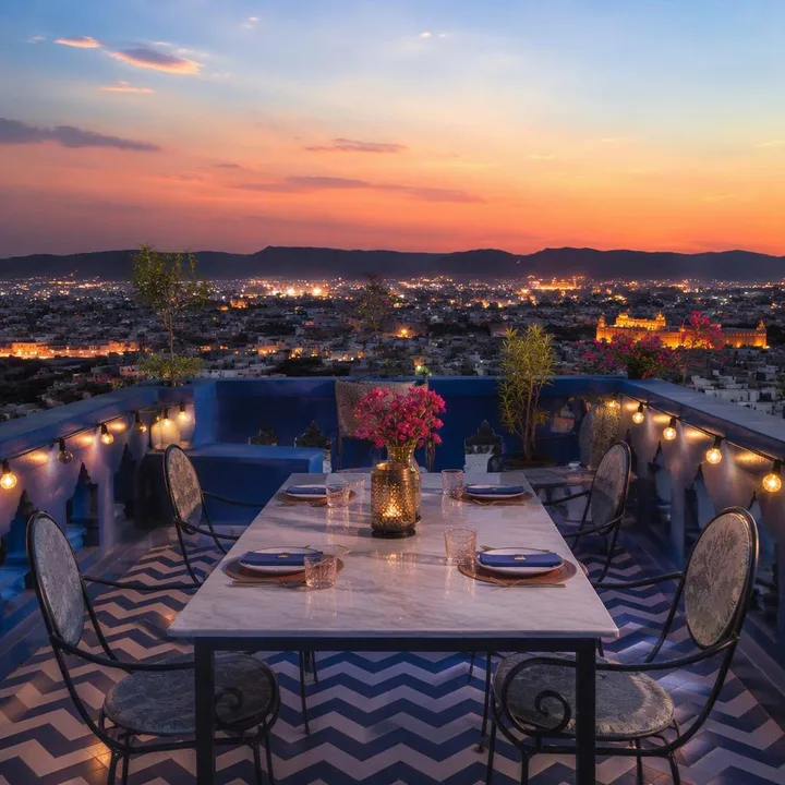 Rooftop table with Jaipur skyline at dusk for kitty party photos at Nouba Restaurant and Rooftop Lounge, C-Scheme Jaipur