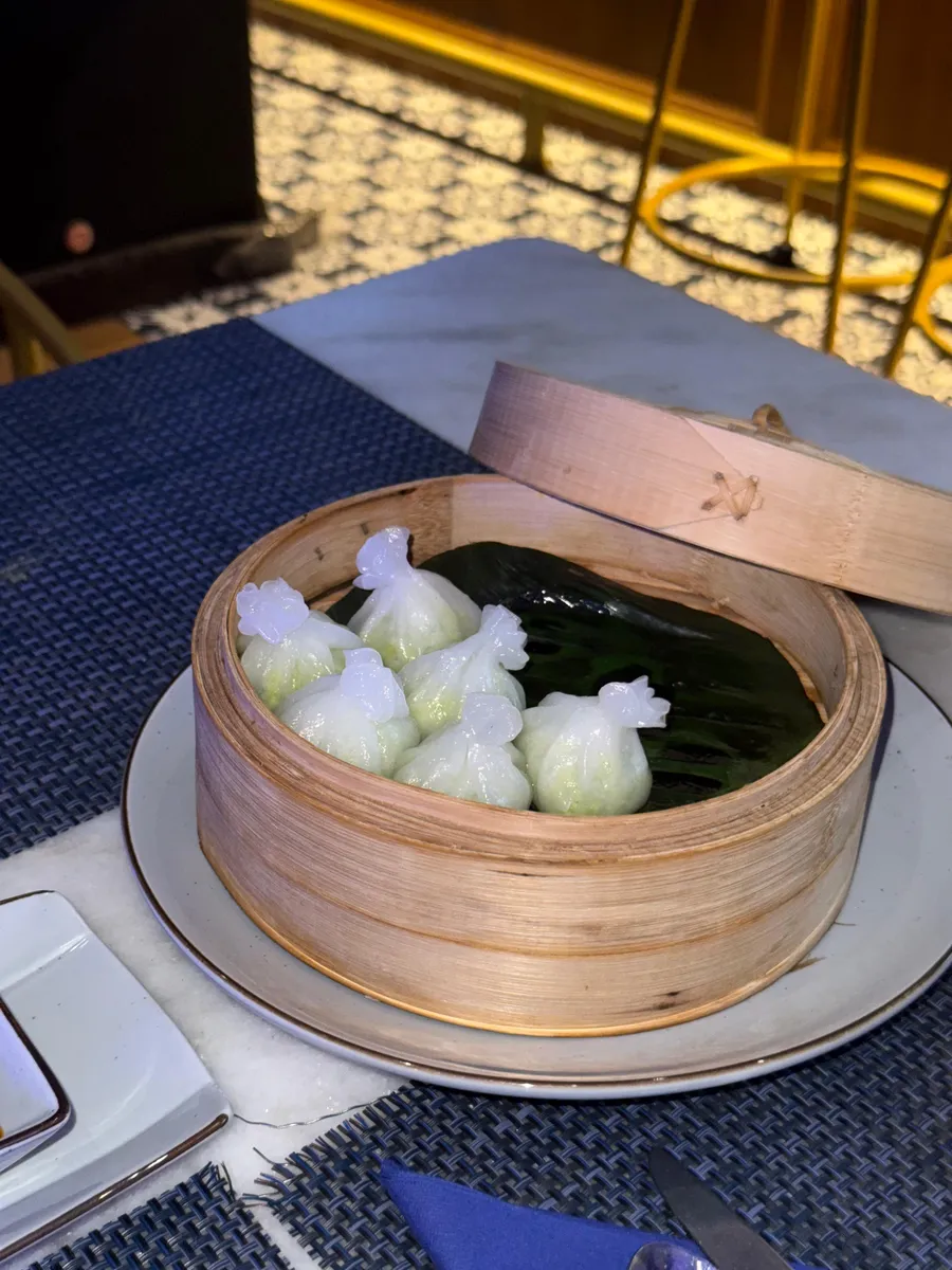 Steamed dumplings in a bamboo basket at Nouba Jaipur