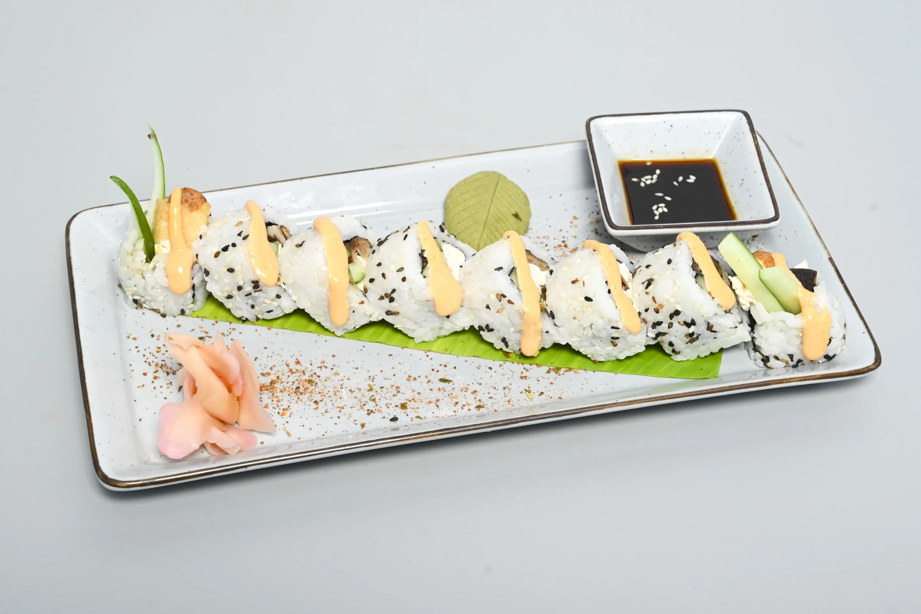 Sushi roll with sesame and sriracha mayo at Nouba
